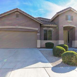 A suburban house with a two-car garage and well-maintained landscaping.