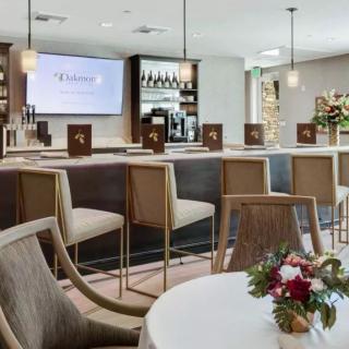 Modern bar interior with sleek seating and floral arrangements.