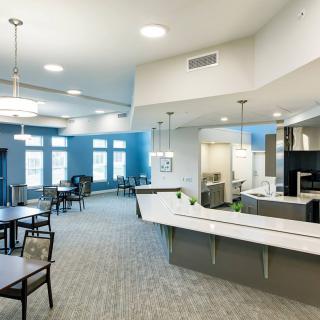 A modern open-plan kitchen and dining area with contemporary furniture and stylish lighting.