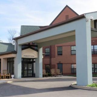 The exterior view of a hotel entrance with a covered driveway.