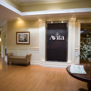 A welcoming lobby area with elegant decor and seating, featuring a prominent sign for Avila.