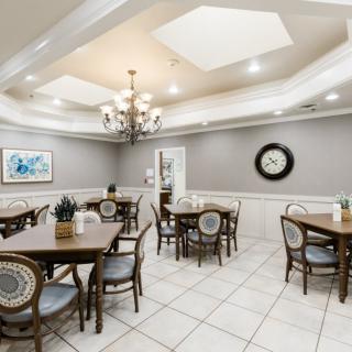 A well-lit dining area with classic furniture and stylish decor.