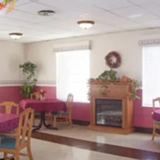 A cozy dining area with a fireplace and colorful decor.