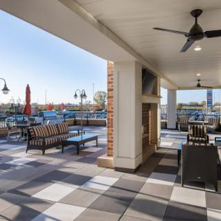 A stylish outdoor patio featuring comfortable seating and a welcoming atmosphere, perfect for enjoying sunny days.