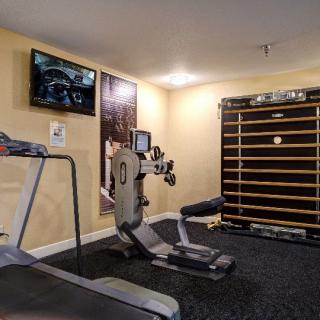 A well-equipped home gym featuring a treadmill and stationary bike, ideal for personal fitness routines.