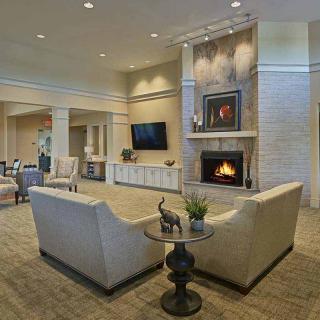 A modern living room featuring a cozy fireplace and stylish decor.