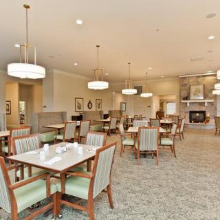 A spacious and well-lit dining area with elegant furnishings and decor.