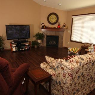 Cozy living room with a fireplace, television, and floral sofa.