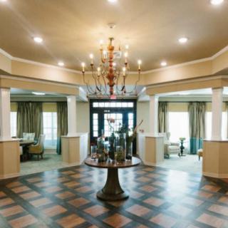 A luxurious lobby featuring elegant decor and a central chandelier.
