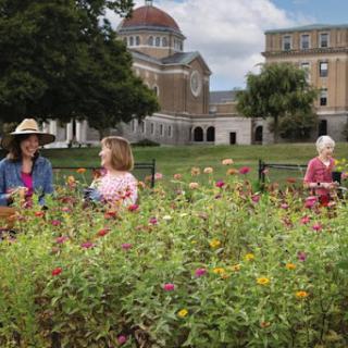 A peaceful afternoon in the park where women enjoy the beauty of blooming flowers.
