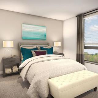 A modern bedroom with stylish decor and large window views.