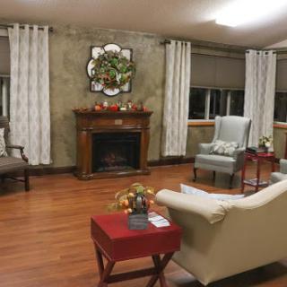 A cozy living room featuring a fireplace, comfortable seating, and tasteful decor.
