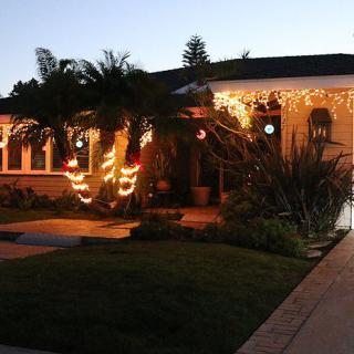 A house adorned with holiday lights in the evening.