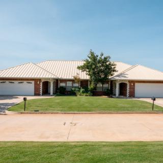 A suburban duplex with a manicured lawn and twin garages.