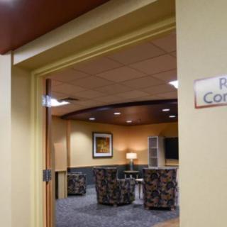 A conference room with comfortable seating and warm lighting.