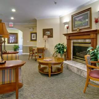A cozy living room with a fireplace, comfortable seating, and elegant decor.