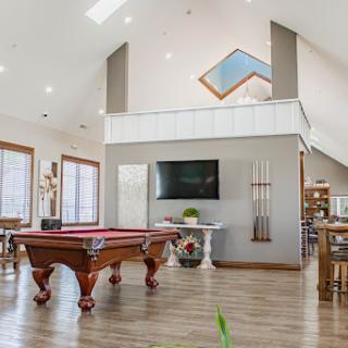 A spacious and modern living area featuring a pool table, perfect for entertaining and leisure.