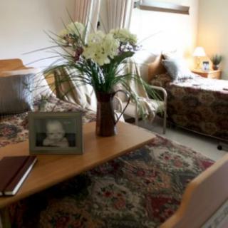 A cozy living room with a floral arrangement on the table.