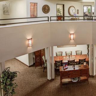 A spacious office interior with a large conference table and elegant lighting fixtures.