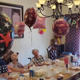 A joyful birthday celebration with balloons and laughter shared among family members.