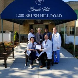 Medical team gathered outside Brush Hill facility, celebrating their achievements.