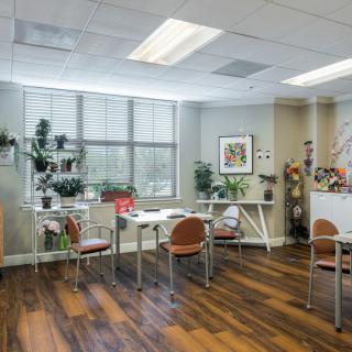 A modern office workspace with plants and natural lighting.