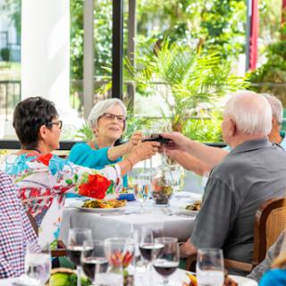 A joyful gathering of friends enjoying dinner and toasting to cherished moments.