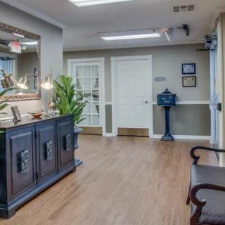 A cozy reception area with decorative elements and wooden flooring.