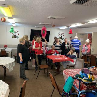 A lively gathering at a community event with decorations and engaged attendees.