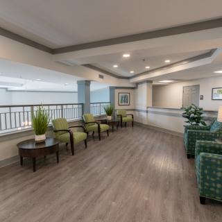 A modern lobby with seating areas and indoor plants.