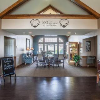 A welcoming lobby interior with comfortable seating and a decorative welcome sign.