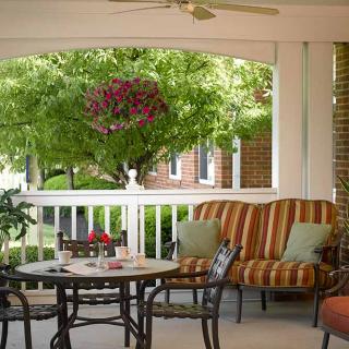 A cozy patio with comfortable seating and a garden view, perfect for relaxation.