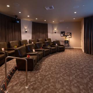A luxurious home theater with comfortable seating and ambient lighting.