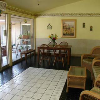 A cozy living and dining area with wooden furniture and tile flooring.