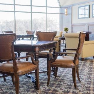 Spacious lounge area with elegant furniture and large windows.