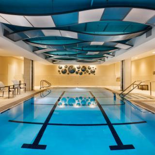 A luxurious indoor swimming pool with modern architectural design elements.