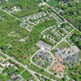 Aerial view of a suburban neighborhood surrounded by greenery.