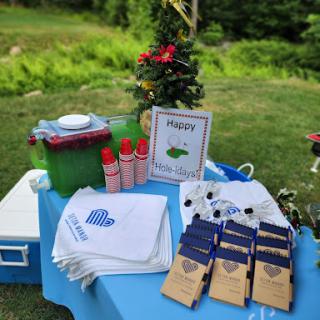 A cheerful outdoor setup featuring refreshments and decorative elements for a gathering.