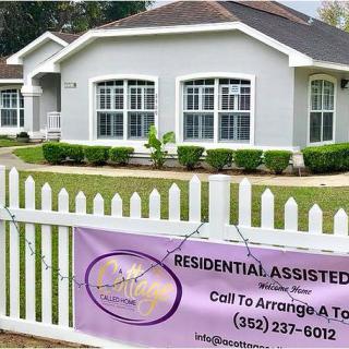 Residential assisted living facility with a sign on the fence providing contact information for tours.