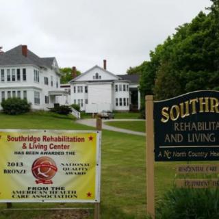 Southridge Rehabilitation and Living Center with signs displayed in the front lawn.