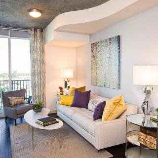 A modern living room with colorful pillows and contemporary decor.