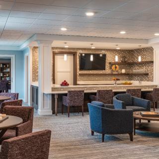 A modern living space featuring a bar counter and comfortable seating area.
