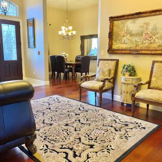 A cozy living room with elegant decor and a dining area in the background.