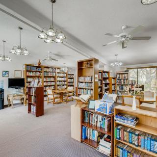 A spacious library with bookshelves and a comfortable reading area.