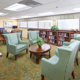 A cozy library seating area with armchairs and bookshelves.