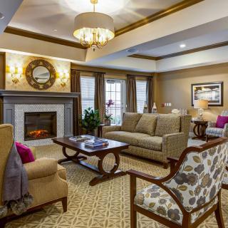 A cozy and elegantly decorated living room featuring a fireplace, comfortable seating, and stylish decor.