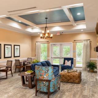 A modern living room with stylish furnishings and a chandelier.