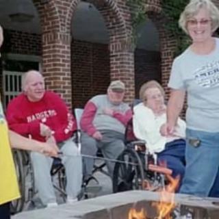 A group of people enjoying time together around a fire pit.