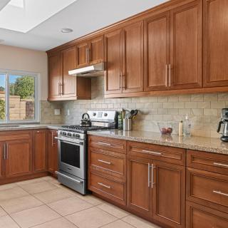 A modern kitchen with wooden cabinets and stainless steel appliances.