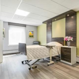 A modern hospital room with a bed and minimalist decor.